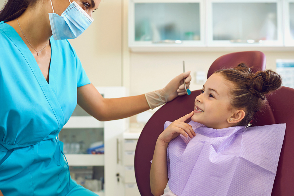 Dentist in Woodbridge examining child's teeth at Vellore Corners Dentistry